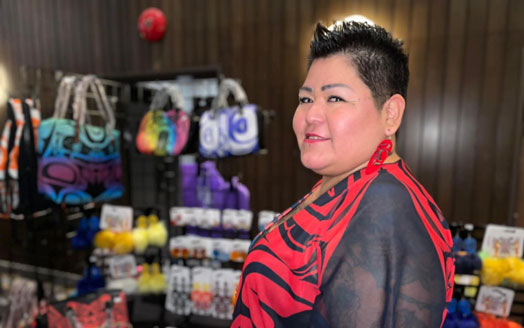 Artist with display of bags and accessories