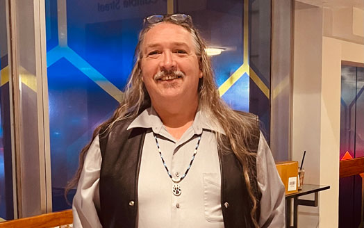 Artist wearing beadwork necklace